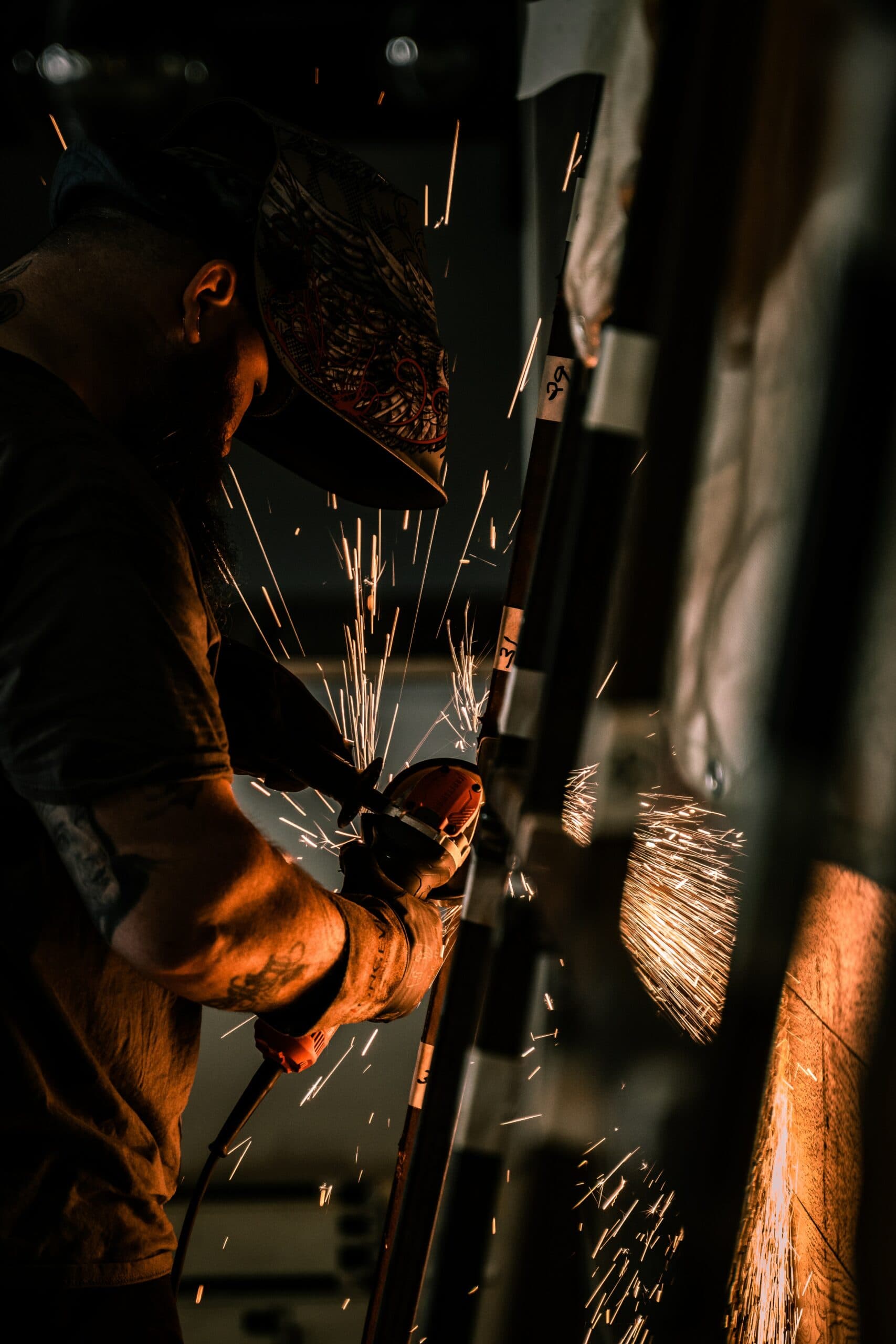 Employee grinding a workpiece with flying sparks